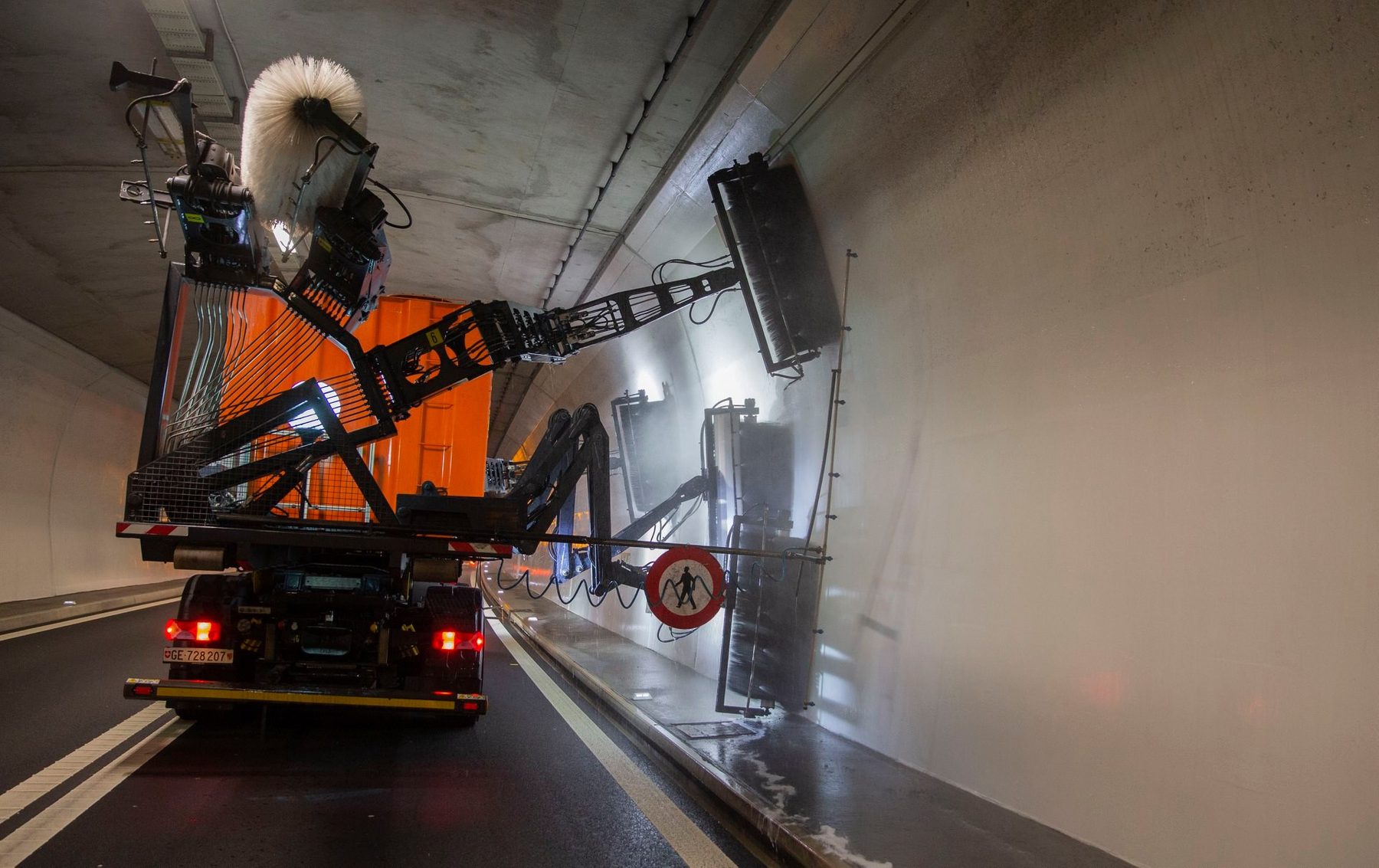 The Octopus tunnel washing truck cleaning a road tunnel with articulated brush arms